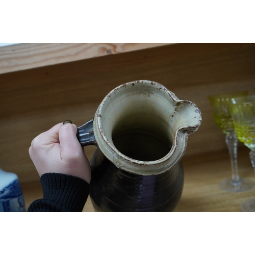 364 - Richard Batterham (1936-2021), a tall stoneware black glazed jug, with a cream rim. 28cm high. Condi... 