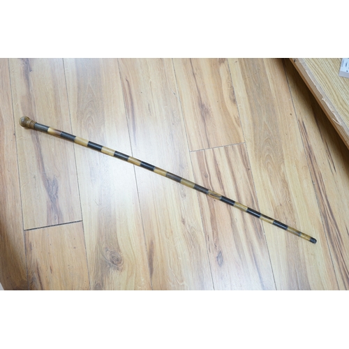 383 - An African two colour banded horn walking stick with turned handle, 87cm in length. Condition - fair... 