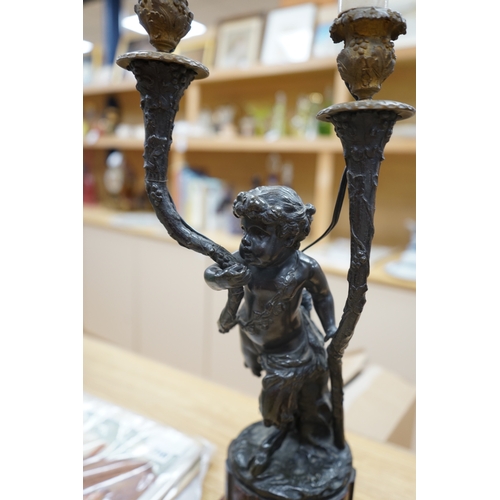 387 - A pair of French bronze cupid twin candelabra with leaf shaped twin arms upon rouge marble fluted co... 