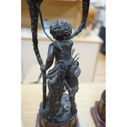 387 - A pair of French bronze cupid twin candelabra with leaf shaped twin arms upon rouge marble fluted co... 