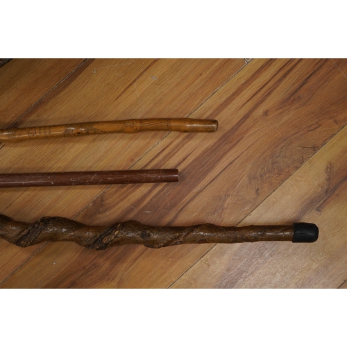 391 - Three novelty walking sticks and gouged gathering bowl. Condition - fair