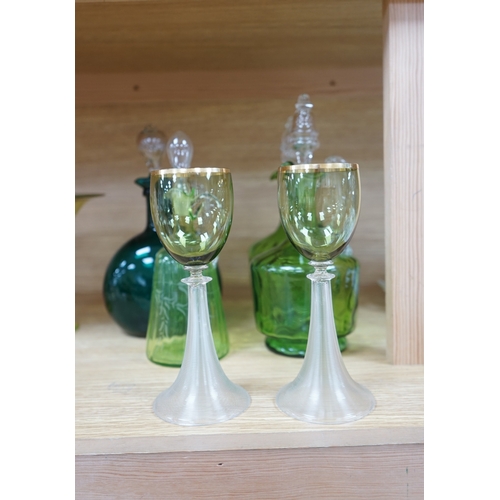 396 - Ten glass items; a pair of green hock glasses, six liqueur decanters, a pedestal table centre and a ... 