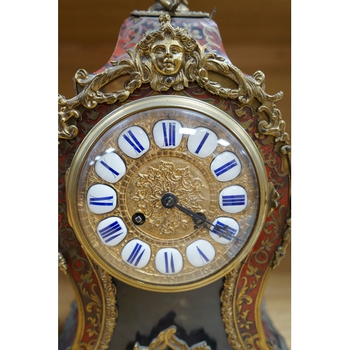 410 - A French scarlet Boulle clock, and original bracket, the waisted case with glass front enclosing bou... 