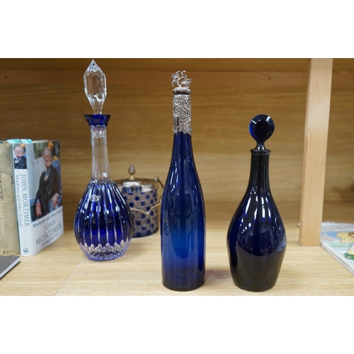 413 - A collection of blue glassware comprising a late 18th century Bristol blue glass decanter and tear d... 