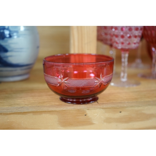 422 - Two cranberry glass liqueur decanters and a collection of various glasses and a bowl, decanters 25cm... 