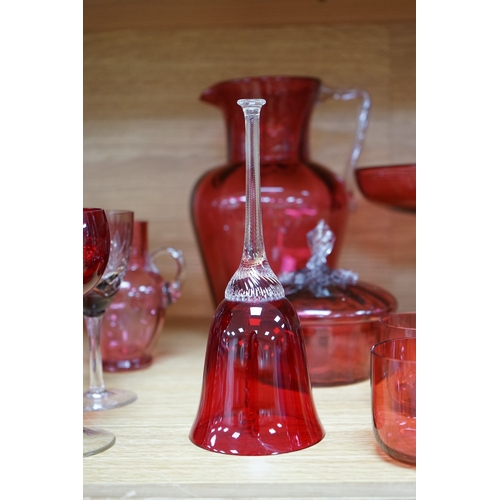 424 - Mixed cranberry glassware to include jugs, glasses, jars and a comport, largest 23cm high. Condition... 