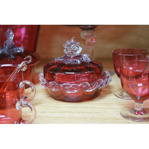 424 - Mixed cranberry glassware to include jugs, glasses, jars and a comport, largest 23cm high. Condition... 