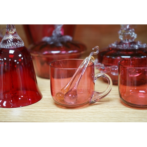 424 - Mixed cranberry glassware to include jugs, glasses, jars and a comport, largest 23cm high. Condition... 