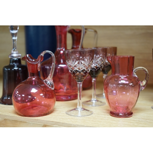 424 - Mixed cranberry glassware to include jugs, glasses, jars and a comport, largest 23cm high. Condition... 