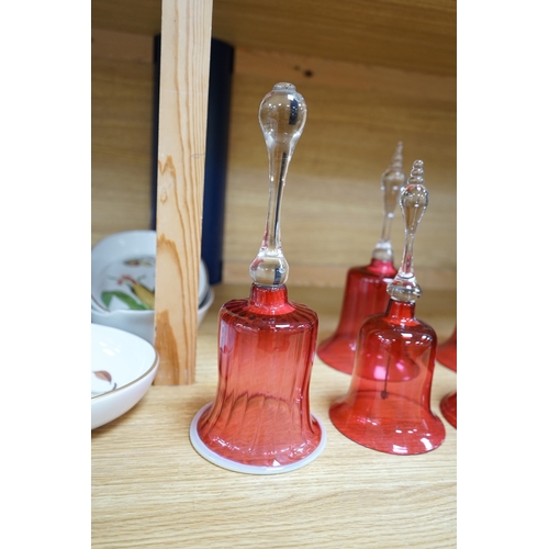 435 - Seven 19th century cranberry glass hand bells, various sizes, largest 30.5cm high. Condition - fair... 