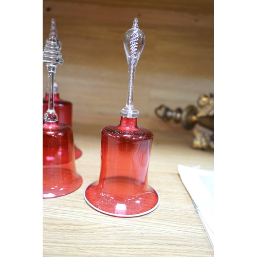 435 - Seven 19th century cranberry glass hand bells, various sizes, largest 30.5cm high. Condition - fair... 