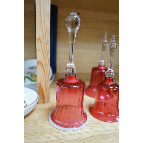 435 - Seven 19th century cranberry glass hand bells, various sizes, largest 30.5cm high. Condition - fair... 