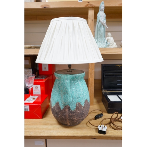 469 - A turquoise lava ceramic table lamp with fabric shade, wired, 61cm to top of shade, 33cm high exclud... 