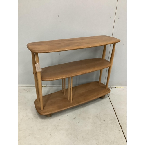 48 - An Ercol Windsor elm and beech three tier book trolley, model 361. Width 91cm, depth 32cm, height 71... 