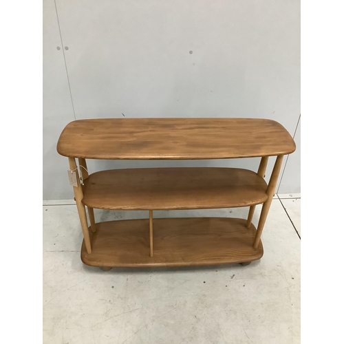 48 - An Ercol Windsor elm and beech three tier book trolley, model 361. Width 91cm, depth 32cm, height 71... 