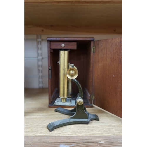 481 - A Victorian brass microscope, J T Slugg, Manchester, in original wooden case, with a small selection... 