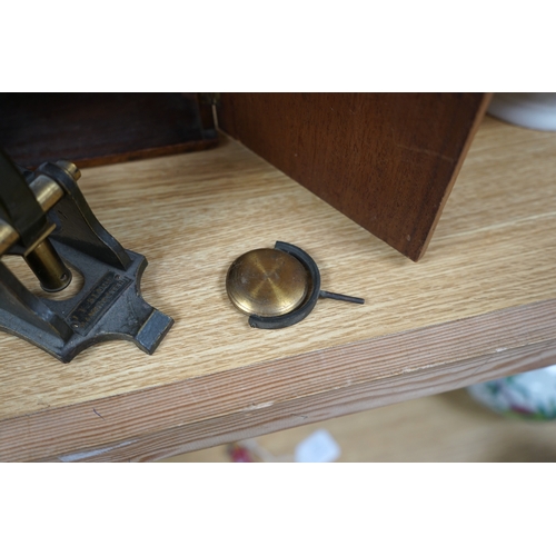 481 - A Victorian brass microscope, J T Slugg, Manchester, in original wooden case, with a small selection... 