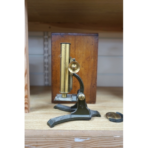 481 - A Victorian brass microscope, J T Slugg, Manchester, in original wooden case, with a small selection... 