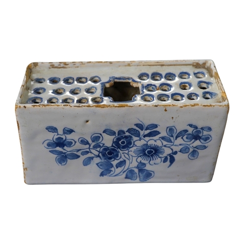 488 - An 18th century English delftware flower brick, 15cm wide, 8cm high. Condition - edges chipped and l... 