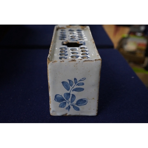 488 - An 18th century English delftware flower brick, 15cm wide, 8cm high. Condition - edges chipped and l... 