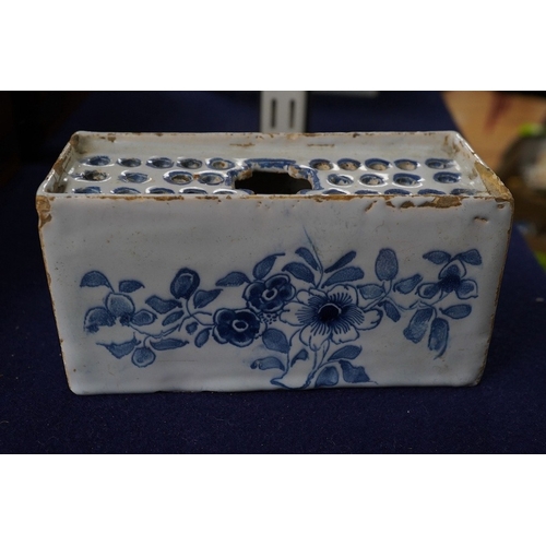 488 - An 18th century English delftware flower brick, 15cm wide, 8cm high. Condition - edges chipped and l... 