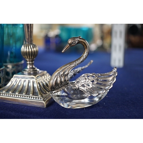 493 - Four coloured glasses with silver stands a similar glass swan salt, a three piece cruet with white m... 