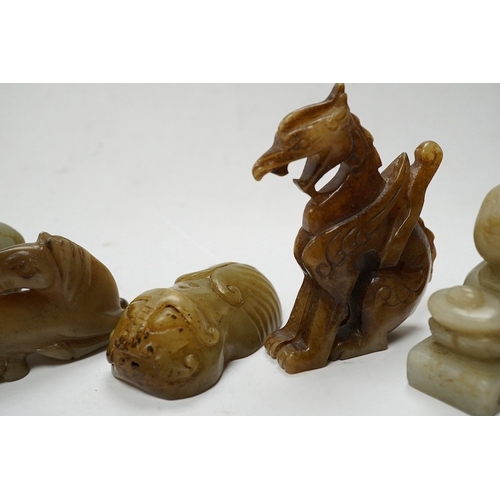 502 - Four Chinese jade carvings, of a horse, cicada, a winged beast, a kneeling man, and a horned beast, ... 