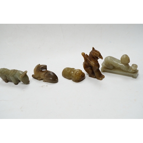 502 - Four Chinese jade carvings, of a horse, cicada, a winged beast, a kneeling man, and a horned beast, ... 