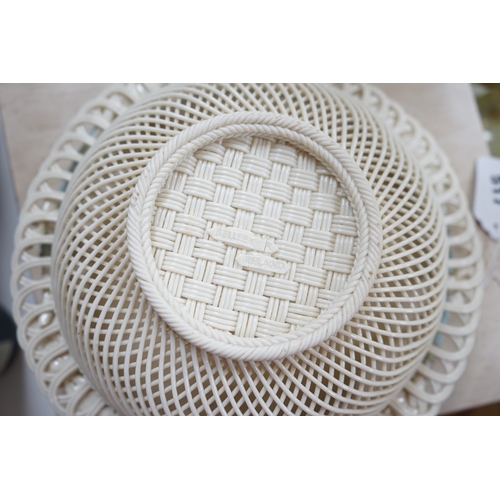 517 - A boxed Belleek coloured basket, 28cm diameter. Condition - fair to good, some damage and wear to th... 