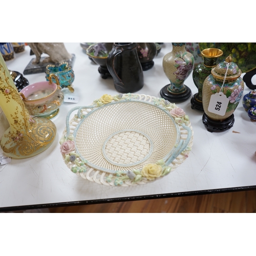 517 - A boxed Belleek coloured basket, 28cm diameter. Condition - fair to good, some damage and wear to th... 