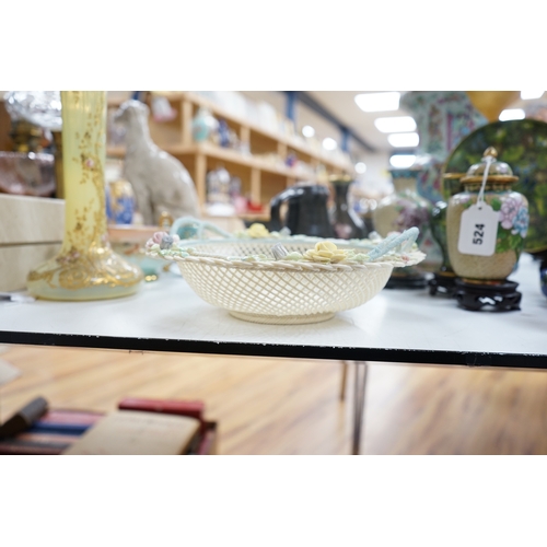 517 - A boxed Belleek coloured basket, 28cm diameter. Condition - fair to good, some damage and wear to th... 