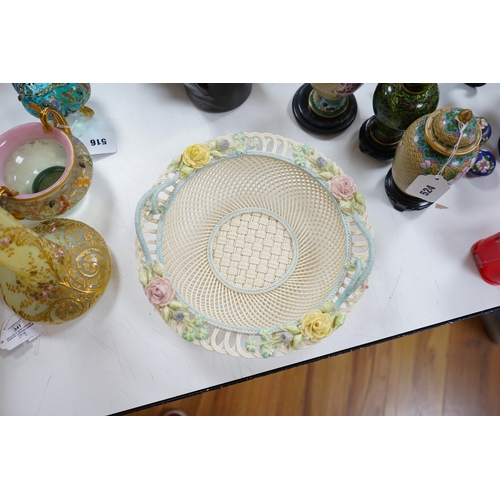 517 - A boxed Belleek coloured basket, 28cm diameter. Condition - fair to good, some damage and wear to th... 