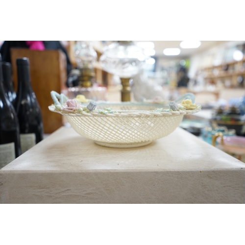 517 - A boxed Belleek coloured basket, 28cm diameter. Condition - fair to good, some damage and wear to th... 