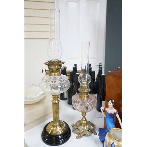 519 - Two brass oil lamps with glass spirit tanks, tallest 67cm. Condition - good.