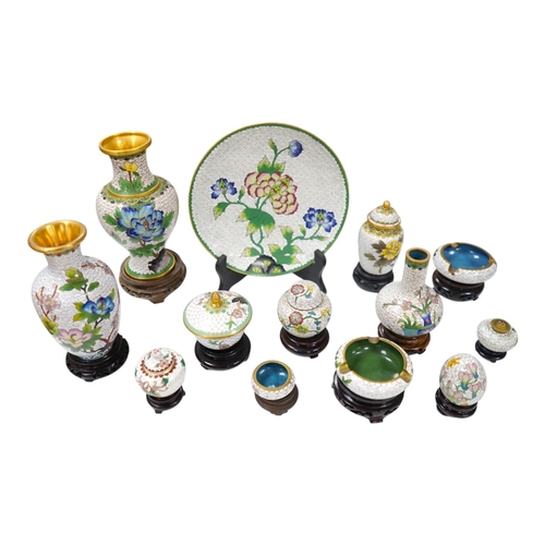 522 - A collection of Chinese cloisonné enamel vases, pots etc., all worked on a white background in flora... 