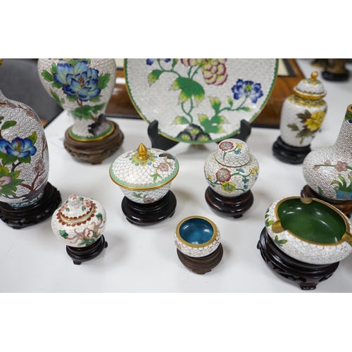 522 - A collection of Chinese cloisonné enamel vases, pots etc., all worked on a white background in flora... 