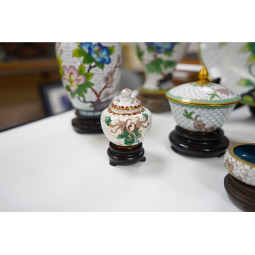 522 - A collection of Chinese cloisonné enamel vases, pots etc., all worked on a white background in flora... 