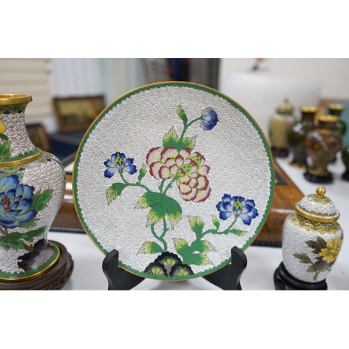 522 - A collection of Chinese cloisonné enamel vases, pots etc., all worked on a white background in flora... 