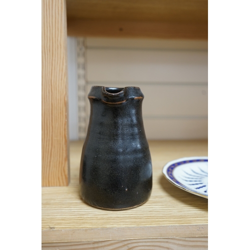 527 - Leach standard ware, a small Stoneware black glazed studio pottery jug, impressed mark to top of foo... 