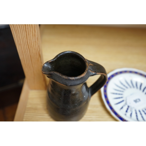 527 - Leach standard ware, a small Stoneware black glazed studio pottery jug, impressed mark to top of foo... 