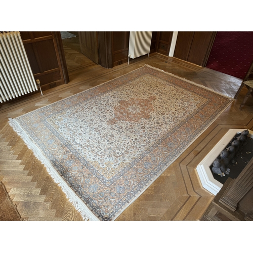 74 - An Isfahan ivory ground rug woven with design, 320 x 215cm. Condition - fair to good