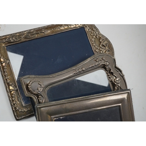 831 - A small George V silver mounted photograph frame, 11.2cm, together with three larger modern silver m... 