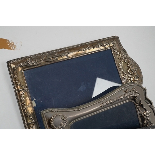 831 - A small George V silver mounted photograph frame, 11.2cm, together with three larger modern silver m... 