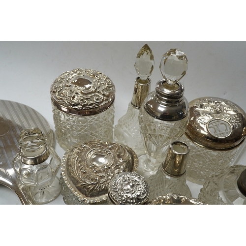 832 - Two silver mounted hand mirrors and a collection of seventeen assorted silver mounted toilet jars. C... 