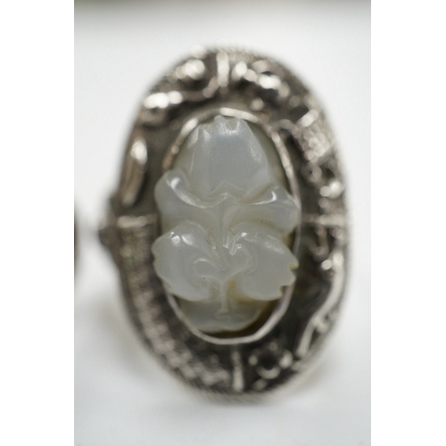 906 - Two Chinese or Burmese jadeite or jade mounted white metal rings. Condition - fair