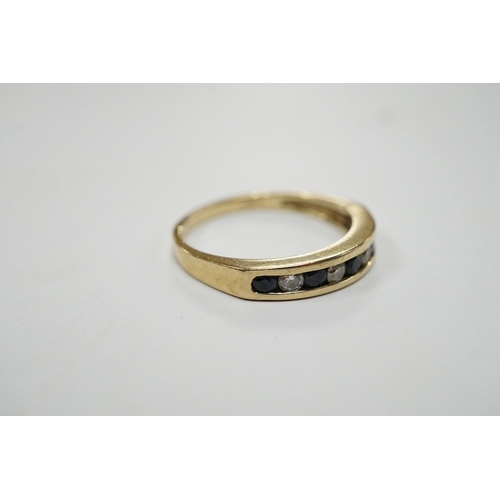 908 - A modern 9ct gold and channel set sapphire and diamond set half hoop ring, size N/O, gross weight 2.... 