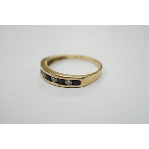 908 - A modern 9ct gold and channel set sapphire and diamond set half hoop ring, size N/O, gross weight 2.... 