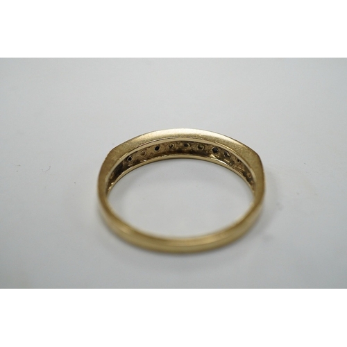 908 - A modern 9ct gold and channel set sapphire and diamond set half hoop ring, size N/O, gross weight 2.... 