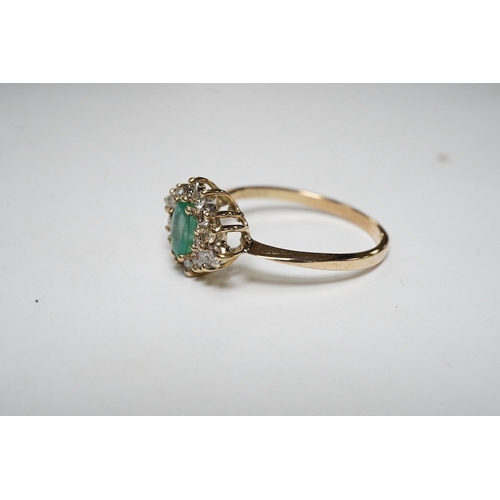 918 - A yellow metal, emerald and diamond cluster set navette shaped ring, size P, gross weight 2.3 grams.... 