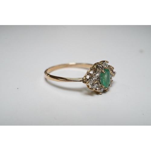 918 - A yellow metal, emerald and diamond cluster set navette shaped ring, size P, gross weight 2.3 grams.... 